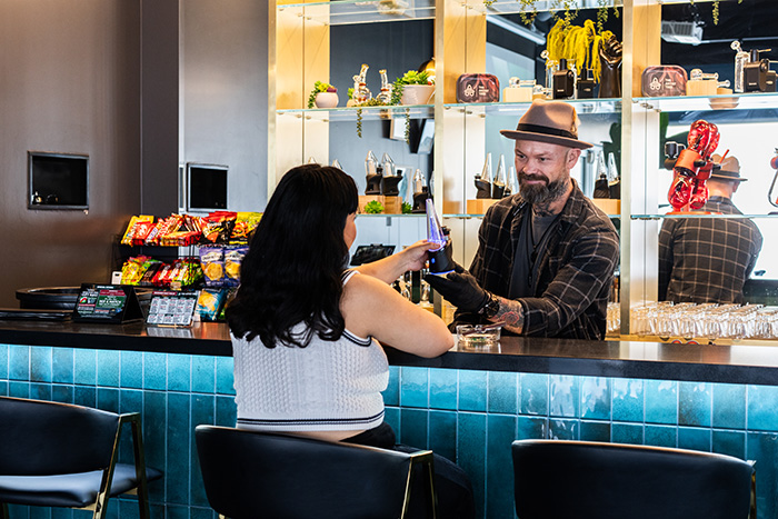 Barman handing a device