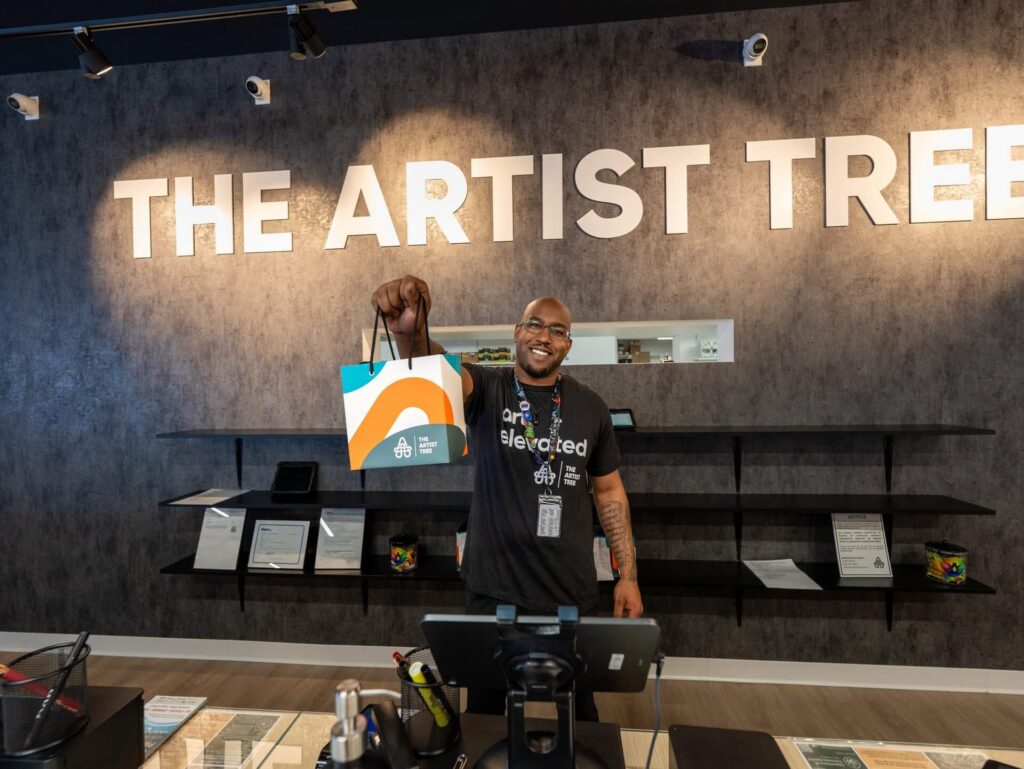 the artist tree employee holding a bag