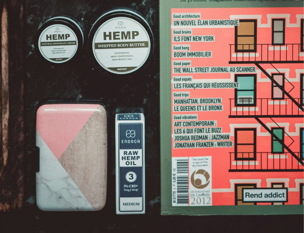 Flat lay of hemp body butter and cream jars with a boxed hemp oil, examples of cannabis topicals